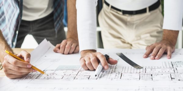 close-up-two-male-architect-s-hand-blueprint